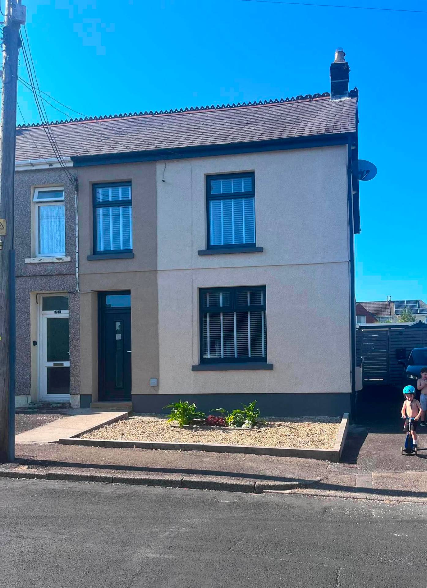 Terraced house with dark grey sprayed UPVC window frames